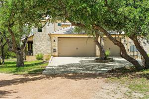 a house with a garage with a driveway at Big Red Chicken Estate in Wimberley +62 photos