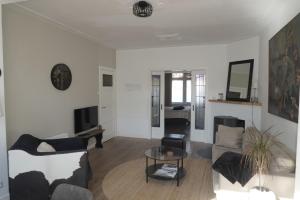 a living room with a couch and a table at Next To Sea in Vlissingen