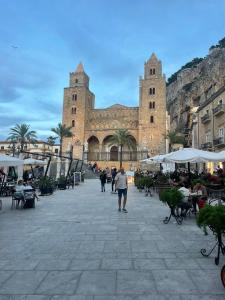 a man standing in front of a large building at dellarocca4 in Cefalù