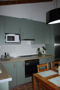 a kitchen with a stove and a microwave at Casa Calera in Nerja