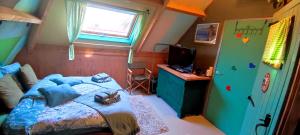 a bedroom with a bed and a tv in it at B&B De Zwerver in Oldehove
