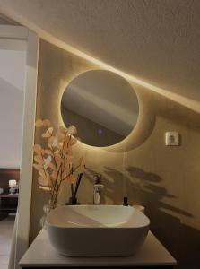 a bathroom with a white sink and a mirror at Solmare Neum Apartmani in Neum +65 photos