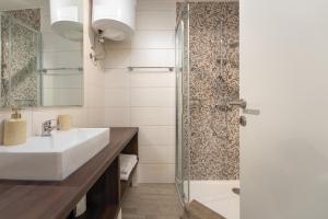 a bathroom with a sink and a shower at Degrassi Square Apartments in Vrsar