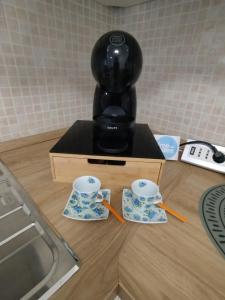 a coffee maker sitting on a counter with two cups at SanRaffaele 117 - Ospedale & Metro Milano - Intero Appartamento in Vimodrone +14 photos