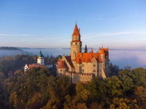a castle on top of a hill with trees at Apartmany a Ubytovani Mlynice Litovel in Litovel