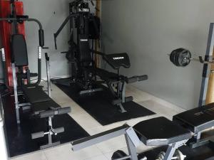 a gym with several treadmills and weights in a room at Haleys Guest House in Benoni +11 photos
