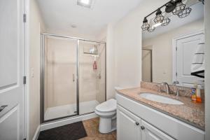 a bathroom with a shower and a toilet and a sink at Hampton Beach OCEAN FRONT Condo at the Surf in Hampton +15 photos