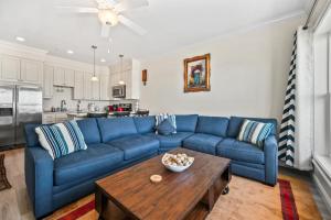 a living room with a blue couch and a table at Hampton Beach OCEAN FRONT Condo at the Surf in Hampton