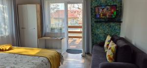 a living room with a couch and a window at Bike & Chill Apartment in Balatonfüred
