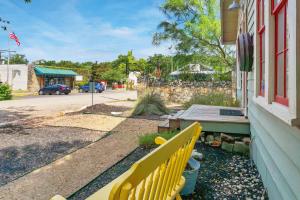 a yellow bench sitting outside of a house at Bungalows on the Square- Unit 1 in Wimberley