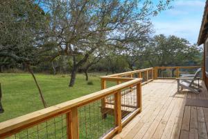 a wooden deck with a bench on top of it at Burnett Ranch Cabins- Prickly Pear in Wimberley