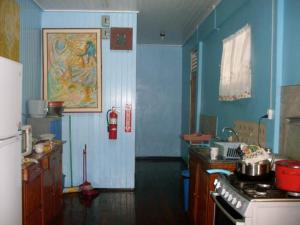 a kitchen with blue walls and a fire extinguisher at Arlington Apartments in Georgetown +9 photos