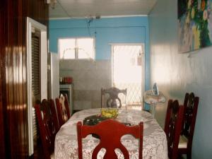 a dining room with a table and chairs in a room at Arlington Apartments in Georgetown