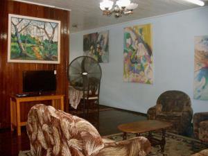 a living room with chairs and a flat screen tv at Arlington Apartments in Georgetown