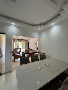 a dining room and living room with a table and chairs at Casa Aurora Provetá - Ilha Grande in Angra dos Reis