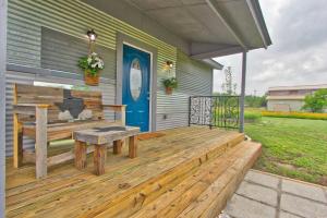 a wooden deck with a bench and a blue door at Blue Jay Getaway in Blanco