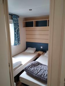 two bunk beds in a room with a bed at MOBIL-HOME n 95 in Barrême