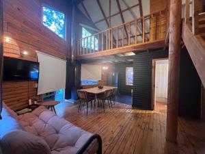 a living room with a large couch and a table at Pangui Lodge in Las Trancas
