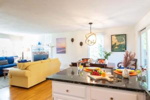 a kitchen and living room with a yellow couch at Spacious w Beautiful Yard & Dogs Welcome in Harwich +21 photos