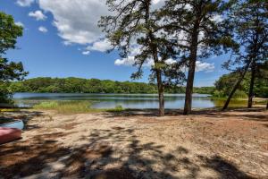 a view of a lake with trees in the foreground at Spacious w Beautiful Yard & Dogs Welcome in Harwich