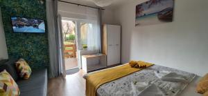 a bedroom with a bed and a television on the wall at Bike & Chill Apartment in Balatonfüred