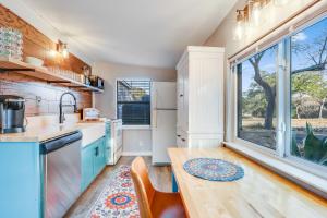 a kitchen with a table and a large window at Bungalow on the Bluff in Fischer
