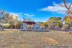 a tiny house in a yard with a fence at Bungalow on the Bluff in Fischer