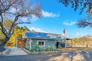 a small house with a flag on top of it at Bungalow on the Bluff in Fischer