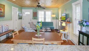 a living room with a table and a couch at Bungalows on the Square- Unit 1 in Wimberley +13 photos