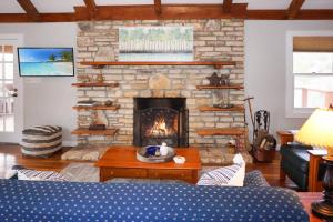 a living room with a stone fireplace with a couch at Burnett Ranch Cabins- Prickly Pear in Wimberley +52 photos