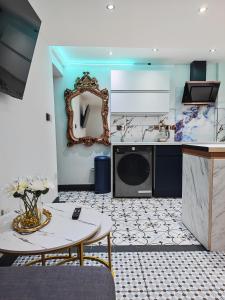 a kitchen with a table and a mirror on the wall at Secret Garden Suite in Gloucestershire