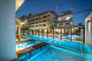a view of a swimming pool at a hotel at Apartamento 2 suítes C/Piscina in Bombinhas