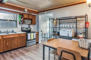 a kitchen with wooden cabinets and a wooden table at Warren County Launchpad: Pet-Friendly Lebanon Apt in South Lebanon