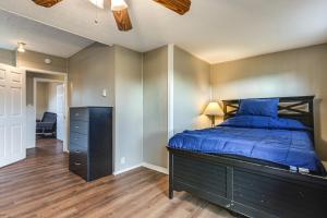 a bedroom with a blue bed and a dresser at Warren County Launchpad: Pet-Friendly Lebanon Apt in South Lebanon
