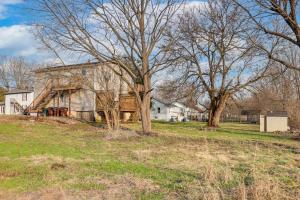 an old house in a field with trees at Warren County Launchpad: Pet-Friendly Lebanon Apt in South Lebanon