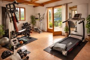 a gym with several treadmills and exercise bikes at B&B Arghjola in Porto-Vecchio