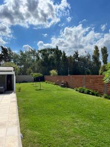 a backyard with a brick wall and a grass yard at La casita in Saladillo