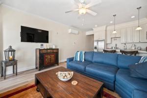 a living room with a blue couch and a table at Hampton Beach OCEAN FRONT Condo at the Surf in Hampton