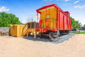 a red and yellow train car sitting on display at Caboose on the Square in Wimberley +30 photos
