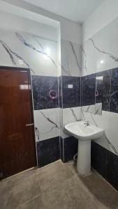 a bathroom with a sink and a shower at hotel Mansion grand in Khammam