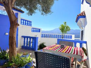 a table with a colorful table cloth on a patio at Casa Olea Vista in Chefchaouen