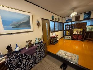 a room with a bed and some vases in it at Blue Art Satoyama Retreat in Ōasa