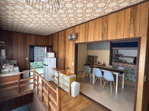 a kitchen and dining room with a table and chairs at Blue Art Satoyama Retreat in Ōasa