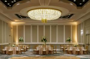 a banquet hall with tables and chairs and a chandelier at Hyatt Regency Reston in Reston +96 photos