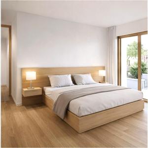 a bedroom with a large bed and two lamps at Chalet Villa Hera in Bichlbach
