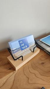 a box on a wooden table next to a laptop at Ô de Caps - à 50m de la plage in Sangatte
