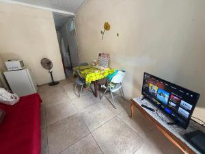 a living room with a table and a television at kolaille chambre HOTE numéro 42 in Saint-Pierre