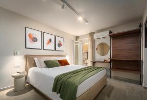a bedroom with a large white bed with green sheets at Degrassi Square Apartments in Vrsar +40 photos