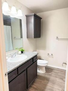 a bathroom with a sink and a toilet at The West House Cozy-Modern-Spacious in Midland