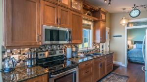 a kitchen with wooden cabinets and a stove top oven at Sunrise Terraces in Ladysmith +18 photos
